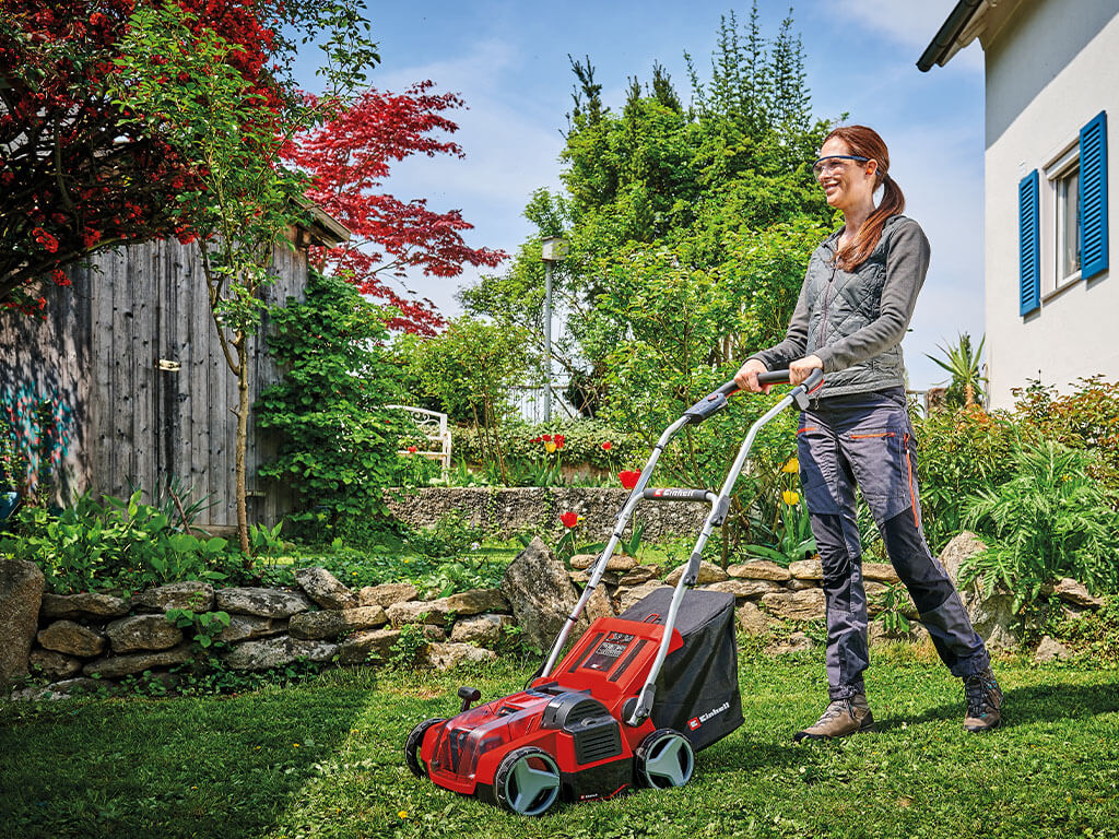 A woman working with a lawn mower