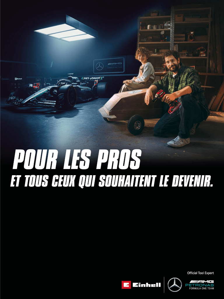Un père et un enfant dans un atelier avec une caisse à savon faite maison. En arrière-plan, une voiture de Formule 1 Mercedes-AMG PETRONAS et des outils Einhell. À droite, il est écrit : « Pour les professionnels et ceux qui veulent le devenir. »