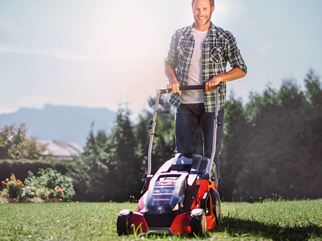 A man working with a lawnmower