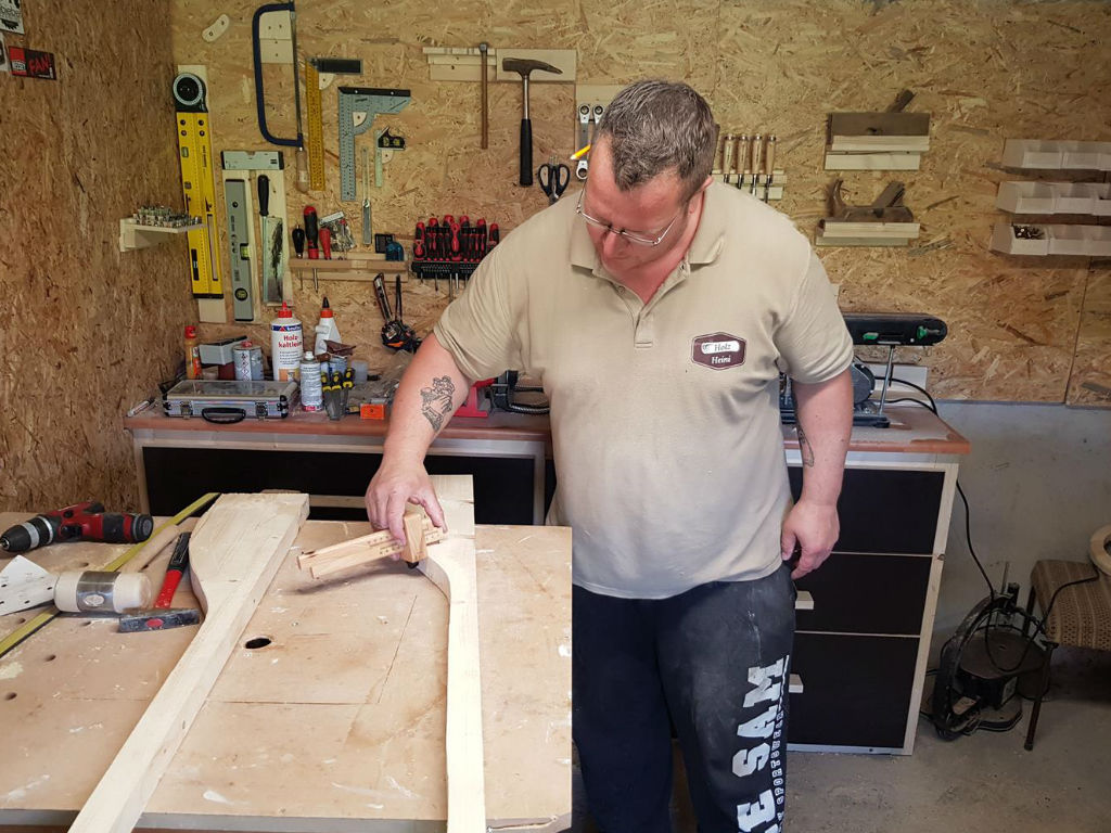 A man is working on the wheelbarrow