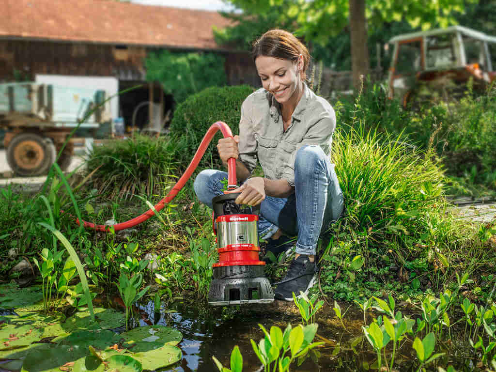 A woman using a water pump.