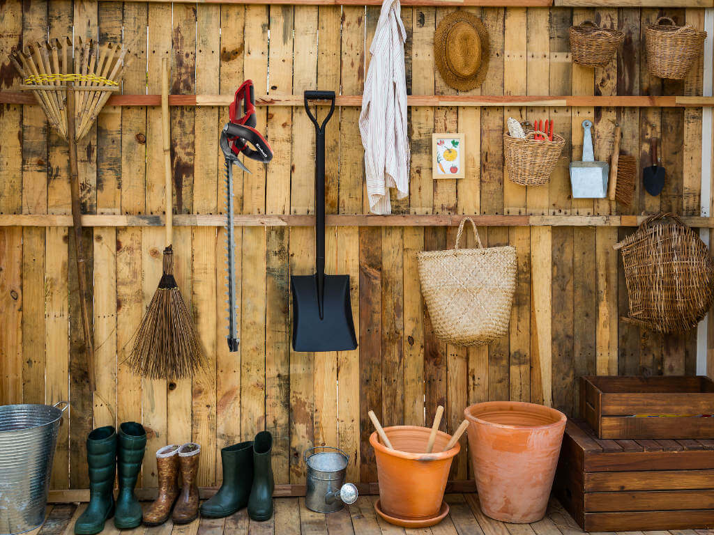 Wall full of garden accessories & clothing. 
