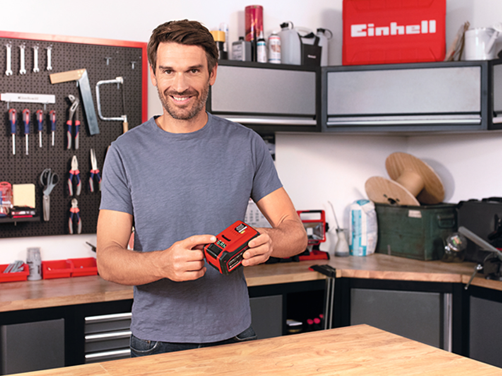 man with pxc battery in a workshop