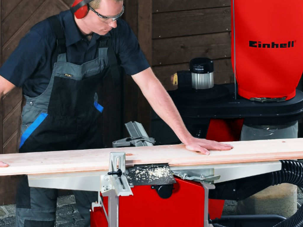 man preparing a piece of wood with einhell tool