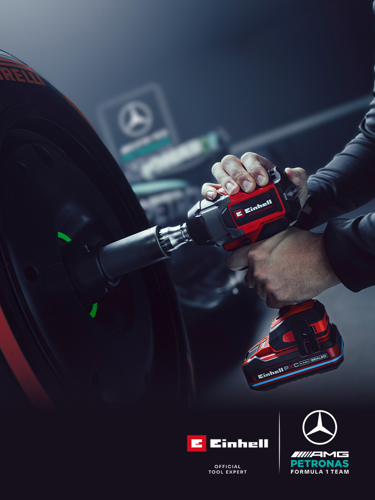 Clé à chocs sans fil Einhell utilisée sur une roue de voiture, avec le branding et le logo de partenariat de l’équipe Mercedes-AMG Petronas de Formule 1