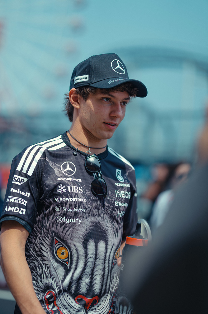 Mercedes F1 driver standing in team gear